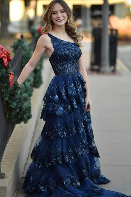 Vestido de gala azul escuro com detalhes rendados e saia fluida, uma escolha clássica e sofisticada inspirada na realeza