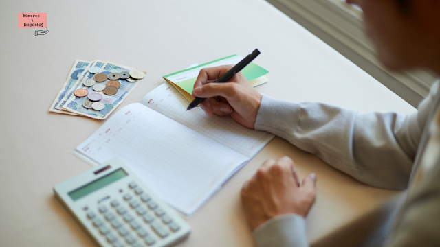 Pessoa a organizar contas e rendimentos para preencher o Anexo B do IRS, com calculadora, caderno e notas de dinheiro.